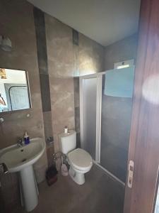 a bathroom with a toilet and a sink and a shower at MAGIC MOON guest house in Famagusta +85 photos