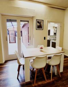 a dining room with a white table and chairs at RNB-Appartments in Bocholt