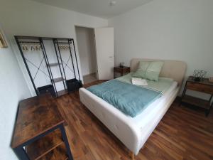a bedroom with a bed and a wooden floor at Stylish, cosy flat close to Cologne City Center in Cologne