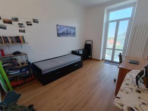 a bedroom with a bed in a room with a window at Casa al mare in Vado Ligure