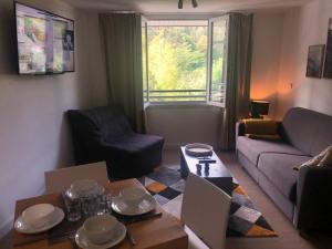 a living room with a couch and a table at [Paradis 401] T2 apaisant au coeur de Lourdes in Lourdes