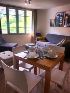 a living room with a wooden table and chairs at [Paradis 401] T2 apaisant au coeur de Lourdes in Lourdes