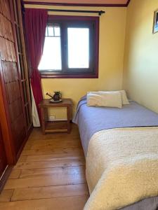 En eller flere senge i et værelse på Hostal Florencia
