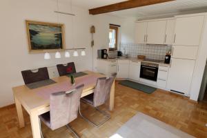 a kitchen with a table and chairs in a room at Ferienhaus Haas inkl. Chiemgaukarte in Ruhpolding