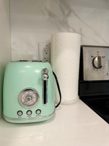 a green toaster sitting next to a roll of toilet paper at Haven Tree Sweet Home in Richmond