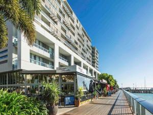 a building with a boardwalk in front of a building at Lovely One Bedroom Apartment "Cairns Harbour Lights" in Cairns
