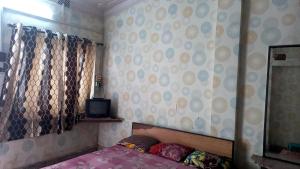 a bedroom with a bed and a mirror at Sea pebbles in Digha