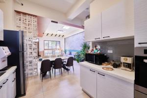 a kitchen and dining room with a table and chairs at HiHi Skylight in Hengchun