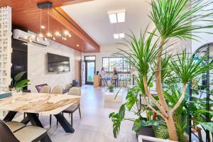 a dining room with potted plants and a table at HiHi Skylight in Hengchun