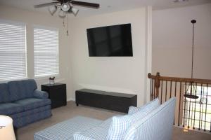 a living room with a couch and a flat screen tv at 4 Bedroom - Luxury Home and Bedding -Sleeps 9 in Humble