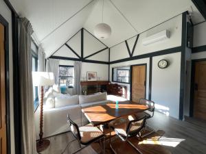 a living room with a table and a couch at The Cottage in Queenstown