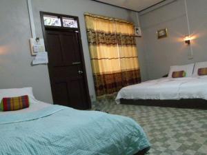 เตียงในห้องที่ Khamphouy Guesthouse