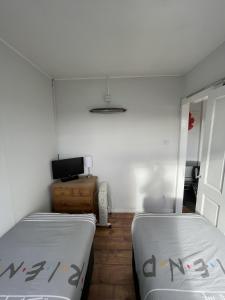 a room with two beds and a television in it at Captivating 2-Bed chalet in Bessingby