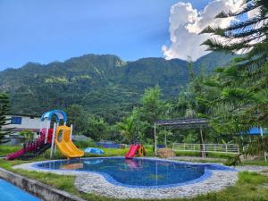 a pool at a resort with mountains in the background at The Heritage at Lamakhet Hotel in Beni