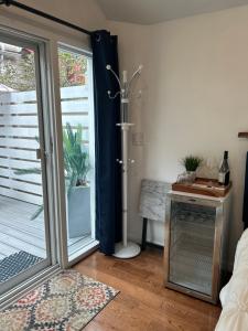 a bathroom with a shower and a sliding glass door at Adorable 1 bedroom cottage in Forest Hills +5 photos