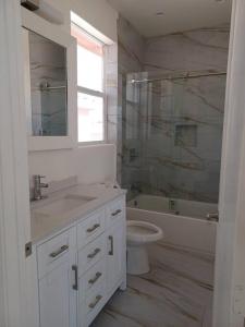 a bathroom with a sink and a toilet and a tub at Newstar Castle in Lancaster +23 photos