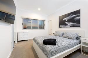 a bedroom with a bed and a large painting on the wall at 22 Cooyou Close in Exmouth