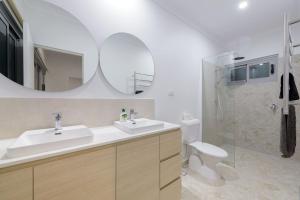 a bathroom with a sink and a toilet and a mirror at 22 Cooyou Close in Exmouth +22 photos
