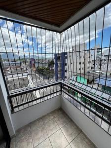 a large window in a building with a view of a city at Apto Completo com 03 Quartos e Wifi 600mbps in Guarapari