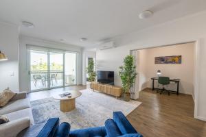 a living room with a couch and a tv at Boulevard North Lakes in North Lakes