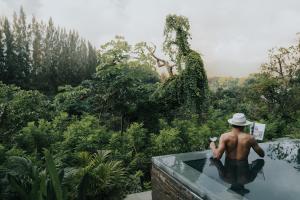 a man in a bath tub in a garden at InterContinental Khao Yai Resort, an IHG Hotel in Mu Si