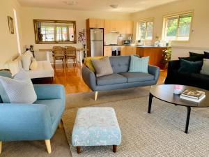 una sala de estar con 2 sofás azules y una mesa. en Luxury Inner City Townhouse en Bendigo