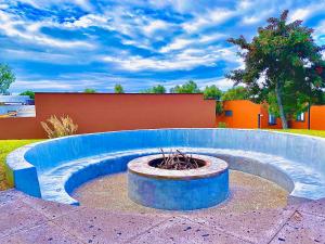 a circular fountain in a yard with a sky at TriBeCa San Miguel in San Miguel de Allende