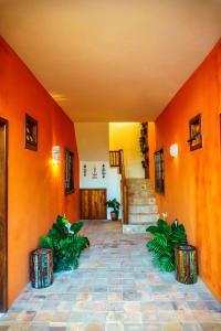 an empty hallway with orange walls and stairs at Pousada Casa Joana Trancoso in Trancoso