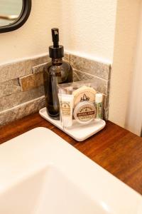 a bottle of soap sitting on a counter next to a sink at Backwoods Cabins in Carson