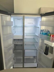 an empty refrigerator with its door open and its at Black Pearl in Guayama