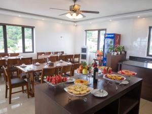 a dining room with a table with food on it at NAM SON HOTEL in Ha Long