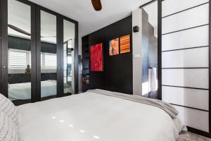a bedroom with a white bed and a large mirror at Best Sydney Views from Potts Point with Rooftop Pool in Sydney +15 photos