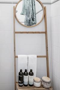 een badkamerplank met een spiegel en 5 flessen bij Coogee Classic - Coastal Gem Close to Beach in Sydney