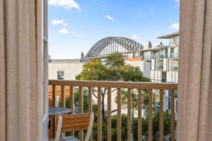 a balcony with a view of the sydney harbour bridge at 'Two of a Kind' Heritage Stay with Harbour Views in Sydney