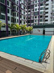 a large swimming pool in front of some buildings at Nureenas Residence Condominium in Ayer Keroh