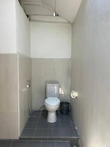 a bathroom with a white toilet in a stall at Pererenan nengah guest house in Canggu