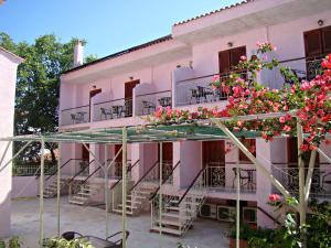 a building with stairs and flowers on it at Kristi in Póros Kefalonias