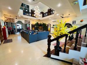 a living room with a staircase and a lobby at Bluemoon Bungalow in Pondicherry