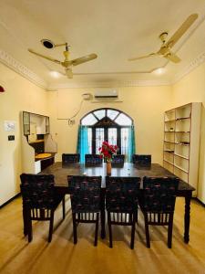 a dining room with a large table and chairs at Bluemoon Bungalow in Pondicherry