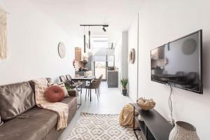 Una sala de estar con un sofá y un televisor de pantalla plana. en Sliema Boutique Apartments by Holi, en Sliema