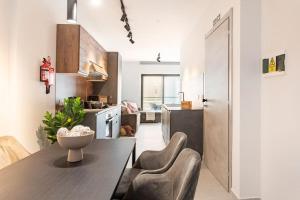a kitchen with a table and chairs in a room at Sliema Boutique Apartments by Holi in Sliema