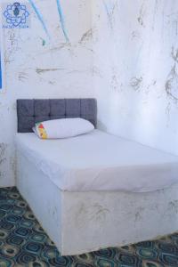 a white bed sitting in a room with at Asilah kato nubian guest house in Aswan