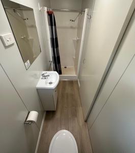 a small bathroom with a toilet and a sink at Roebuck Plains Roadhouse in Broome
