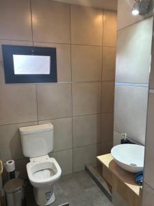 a bathroom with a toilet and a sink at Greca House in Valle Grande +10 photos