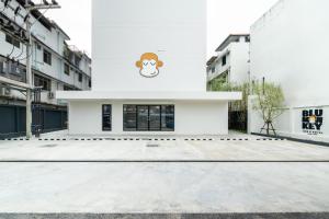 a white building with a monkey painted on it at Newly Opened - Blu Monkey Hub and Hotel Krabi Town in Krabi