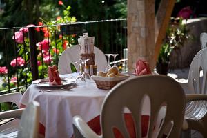 uma mesa com uma toalha de mesa branca com comida em Albergo Milano em Bossico