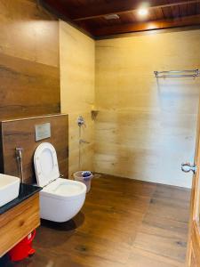 a bathroom with a toilet and a sink at kurinjiyil Farm Stay Munnar in Munnar