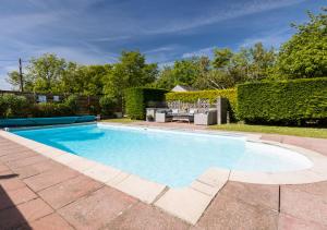 a swimming pool in the backyard of a house at Plas Newydd in Rhiw