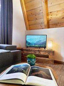 an open book on a coffee table in a living room at Natures Escape Kozarica in Šavnik