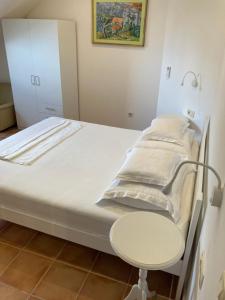 a hospital bed with a table and a chair at guesthouse Libertas 1 in Dubrovnik